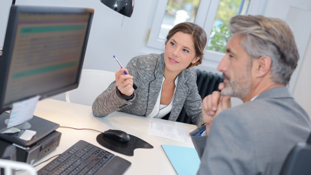 man dealing with a financial adviser at the bank