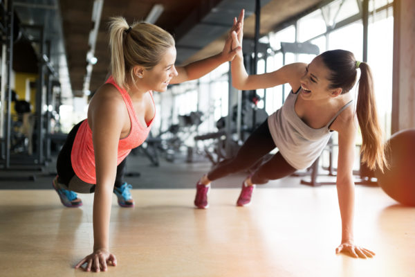 Two women working out in gym