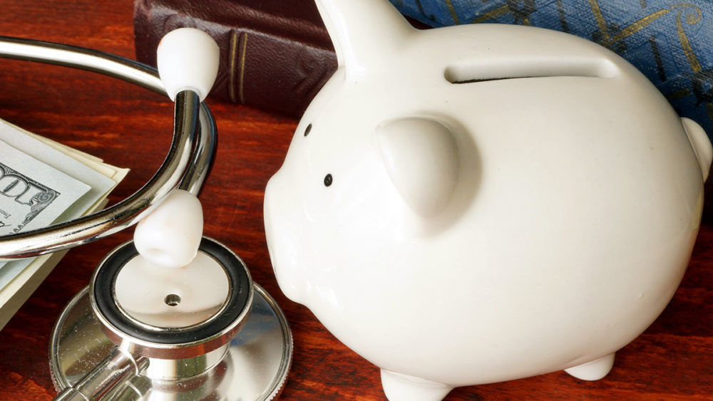 Piggy Bank and stethoscope on a desk